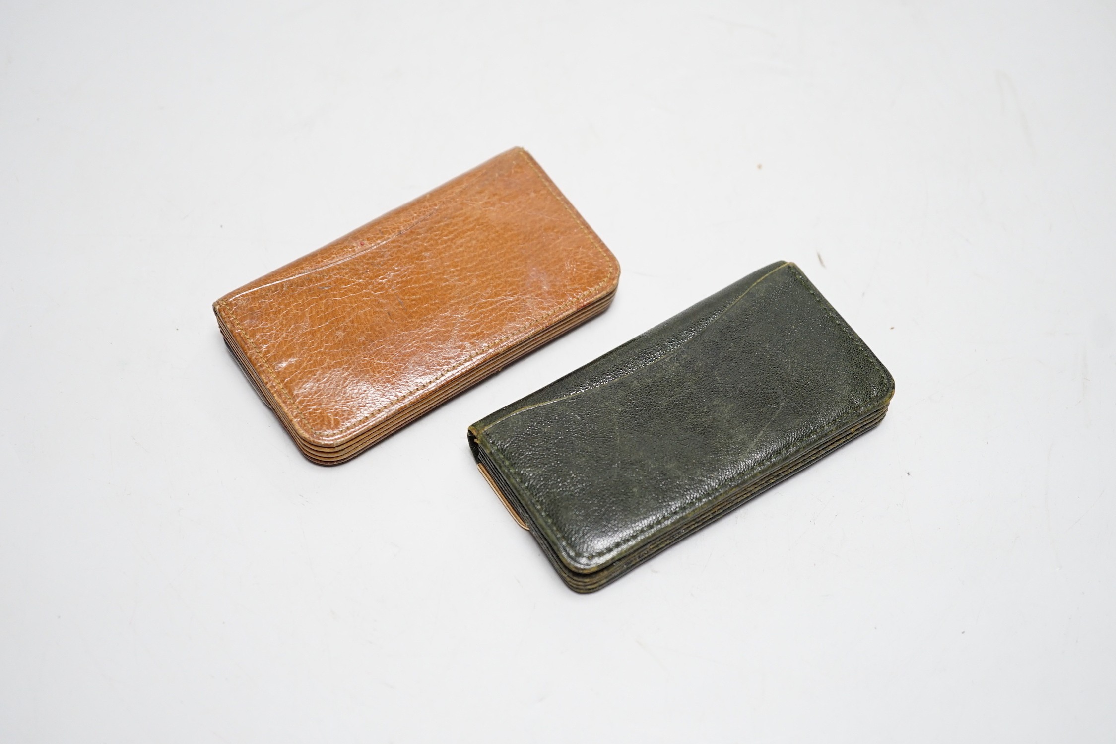 A late Victorian 15ct gold mounted leather purse, 10.3cm and a later silver mounted leather purse.